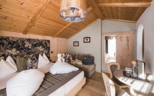 a living room with a couch and a table at Alpine Boutique Villa Gabriela - Adults Only in Castelrotto +29 photos
