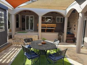 a patio with a table and chairs on a patio at Simply The Choice Manor in Cape Town