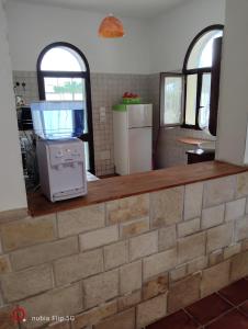a kitchen with a counter with a appliance on it at La casa delle isole in Torre Chianca