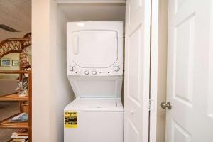 a washer and dryer in a laundry room at Pier Point South Ocean View Condo B-22 in St. Augustine +31 photos