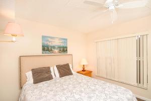 a bedroom with a bed and a ceiling fan at Pier Point South Ocean View Condo B-22 in St. Augustine