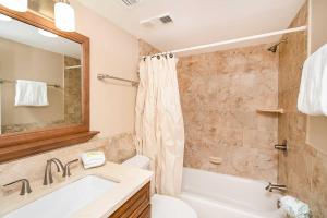 a bathroom with a tub and a toilet and a sink at Pier Point South Ocean View Condo B-22 in St. Augustine