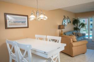 a living room with a white table and a couch at Pier Point South Ocean View Townhouse Condo B-20 in Saint Augustine Beach