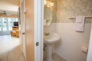 a white bathroom with a sink and a mirror at Pier Point South Ocean View Townhouse Condo B-20 in Saint Augustine Beach