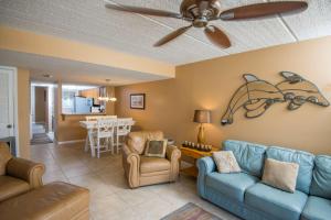 a living room with a blue couch and chairs at Pier Point South Ocean View Townhouse Condo B-20 in Saint Augustine Beach