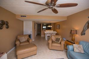 a living room with a ceiling fan and chairs at Pier Point South Ocean View Townhouse Condo B-20 in Saint Augustine Beach