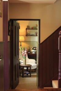 a hallway with a room with a table and a chair at 100 year old family farmhouse in Oldcastle