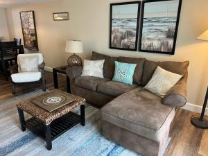 a living room with a couch and a chair at Pier Point South Oceanfront Townhouse Condo E-63 in Saint Augustine Beach +16 photos