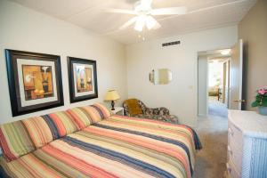 a bedroom with a bed and a ceiling fan at Pier Point South Ocean View Condo B-14 in Saint Augustine Beach