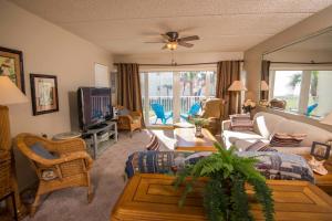 a living room with a couch and a tv at Pier Point South Ocean View Condo B-14 in Saint Augustine Beach