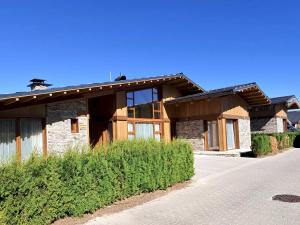 a house with a stone and wood at Pirin Golf Villa Sokol in Bansko