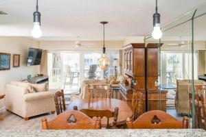 a living room with a table and a couch at Pier Point South Ocean View Condo B-18 in Saint Augustine Beach +23 photos