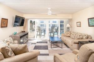 a living room with a couch and a table at Pier Point South Ocean View Condo B-18 in St. Augustine
