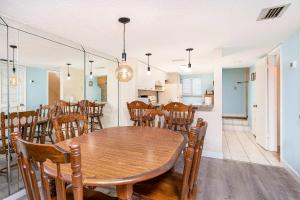 a dining room with a wooden table and chairs at Pier Point South Ocean View Condo B-18 in St. Augustine +20 photos