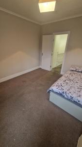 an empty bedroom with a bed and a mirror at Terrace house in Belvedere
