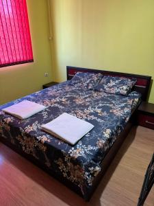 a bedroom with a bed with two towels on it at Апартамент Мони in Veliko Tŭrnovo +5 photos