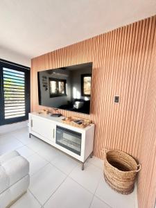 a living room with a mirror on a wall at Casa Blue Laguna2 in Las Croabas +113 photos