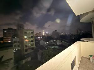 a view of a city at night from a building at Wellness Residencies in Colombo +5 photos