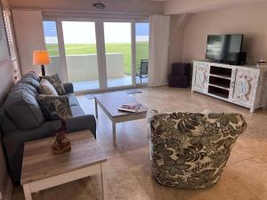 a living room with a couch and a table at Pier Point South Oceanfront Condo A-1 in Saint Augustine Beach