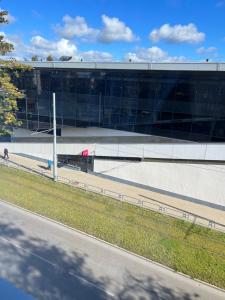 a large glass building with a road in front of it at Fabulous Central Apartment in Daugavpils