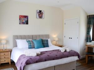 a bedroom with a large bed with towels on it at Bruno's Bothy in Wigton +7 photos