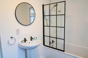 a bathroom with a sink and a mirror at The Butterfield in Liverpool +22 photos