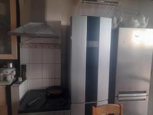 a kitchen with a refrigerator and a stove at Akvarel in Varna City