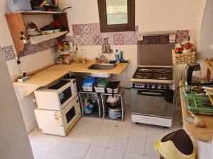 a small kitchen with a sink and a stove at Beat Mousa in Dahab