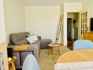a living room with a couch and a table at Serene Coastal Retreat with king Bed & Pool in Lavra in Lavra