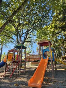 a playground with three slides in a park at Filadélfia Hospedagens e Eventos in São Bento do Sul