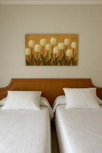 two beds sitting next to each other in a room at El Eden in El Ejido +39 photos