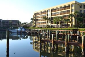 a building next to a body of water with a marina at Midnight Cove II - Sunrise in Siesta Key