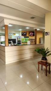 a lobby with a waiting area with a potted plant at Filadélfia Hospedagens e Eventos in São Bento do Sul