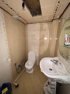 a bathroom with a toilet and a sink at Ramal Apartment in Baku