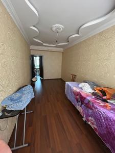 a room with a bed and a table in it at Ramal Apartment in Baku +4 photos