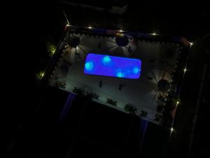 an overhead view of a blue sign at night at Wayma Paradise Resort in Jambiani