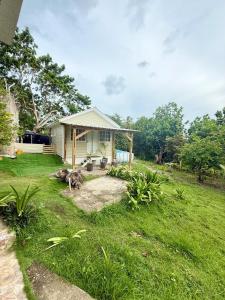 a small house in a grassy yard with a yard at Casa taj beach house in La Loma +7 photos