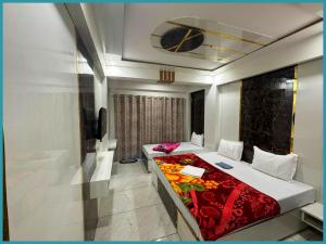 a bedroom with a bed with a red blanket at Hotel Mid-Town Nainital Near Mall Road Free Wifi & Room ServiceAvailable - Luxury Collection of Hotels with Spacious Room - Excellent Customer Service Awarded in Nainital +17 photos