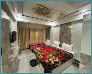 a hotel room with two beds and a television at Hotel Mid-Town Nainital Near Mall Road Free Wifi & Room ServiceAvailable - Luxury Collection of Hotels with Spacious Room - Excellent Customer Service Awarded in Nainital