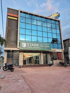 a building with two motorcycles parked in front of it at KN Park in Tiruchirappalli