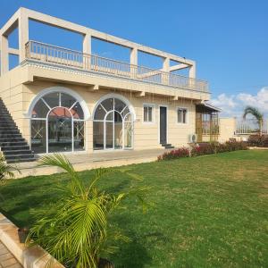 a large house with a lawn in front of it at The Sol Street Villa in Nashik
