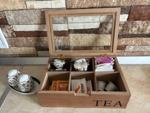 a wooden tea box sitting on the floor with a mirror at Casa Linda in Curtea de Argeş +13 photos