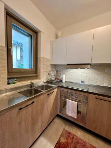 a kitchen with wooden cabinets and a sink and a window at Casa Antonia in Sacco