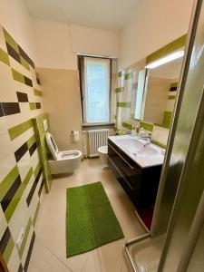 a bathroom with a sink and a toilet and a mirror at Casa Antonia in Sacco