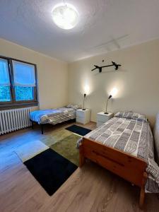 a bedroom with two beds and two windows at Casa Antonia in Sacco