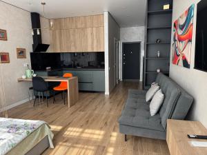 a living room with a couch and a table at Atmosfera Sea View Apartments in Odesa