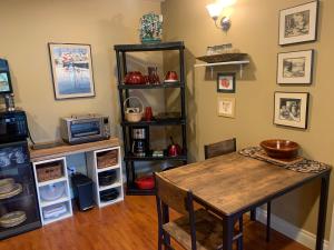 a dining room with a table and a microwave at Shoreside Private room in Sechelt