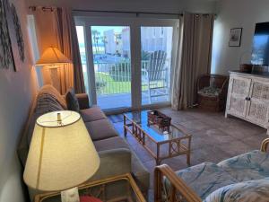 a living room with a couch and a table at Relaxing Poolside Ocean View Townhouse Condo C-32 in Saint Augustine Beach