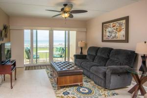 a living room with a couch and a ceiling fan at Pier Point South Oceanfront Townhouse Condo A-3 in Saint Augustine Beach
