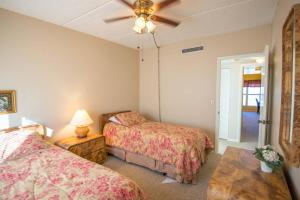 a bedroom with two beds and a ceiling fan at Pier Point South Oceanfront Townhouse Condo A-8 in Saint Augustine Beach